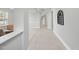 Bright hallway featuring tile flooring and neutral paint, leading to various rooms in the home at 408 Indian Elm Ln, Cary, NC 27519