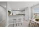 Eat in kitchen with modern white cabinetry, bar top and stainless steel appliances with natural light at 408 Indian Elm Ln, Cary, NC 27519