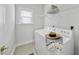 Well-lit laundry room with washer, dryer, and overhead shelf at 408 Indian Elm Ln, Cary, NC 27519