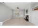 Bright living room featuring a fireplace with built-in cabinets and large window at 408 Indian Elm Ln, Cary, NC 27519