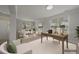 Inviting living space with soft, neutral colors, large windows and ample natural light enhancing the open floorplan at 408 Indian Elm Ln, Cary, NC 27519