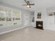 Cozy living room featuring a fireplace with built-in cabinets and large window at 408 Indian Elm Ln, Cary, NC 27519