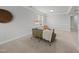 Cozy living room featuring neutral colors and carpeted floors, illuminated by a bright window at 408 Indian Elm Ln, Cary, NC 27519