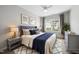 Stylishly staged main bedroom with a decorative rug, upholstered headboard, and ample lighting at 408 Indian Elm Ln, Cary, NC 27519