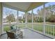 Inviting screened porch with seating overlooking a green, landscaped yard at 408 Indian Elm Ln, Cary, NC 27519