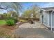 Beautiful backyard featuring a stone patio, lush landscaping, and privacy fence at 410 N Hyde Park Ave, Durham, NC 27703