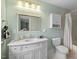 Bathroom with white vanity, modern fixtures, and tiled shower/tub, designed for comfort at 410 N Hyde Park Ave, Durham, NC 27703