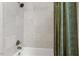 Bathroom with white tile, shower with bronze hardware, and curtain at 410 N Hyde Park Ave, Durham, NC 27703