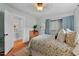 Charming bedroom with light blue walls, hardwood floors, and natural light from the window at 410 N Hyde Park Ave, Durham, NC 27703