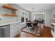 Dining room area with dark wood table, modern chandelier, and large windows with backyard views at 410 N Hyde Park Ave, Durham, NC 27703