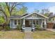 Charming blue craftsman home featuring a cozy front porch with brick accents and inviting curb appeal at 410 N Hyde Park Ave, Durham, NC 27703