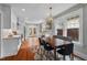 Bright kitchen and dining area featuring stainless steel appliances, white cabinets, and hardwood floors at 410 N Hyde Park Ave, Durham, NC 27703