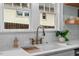 Close up of the kitchen sink, white countertop, and stainless faucet at 410 N Hyde Park Ave, Durham, NC 27703