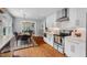 Bright eat-in kitchen with stainless appliances, white cabinets, and a view into the living room at 410 N Hyde Park Ave, Durham, NC 27703