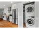 A laundry closet tucked away in the kitchen includes modern washer and dryer units at 410 N Hyde Park Ave, Durham, NC 27703