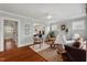 Bright living room featuring hardwood floors, large windows, and stylish furniture at 410 N Hyde Park Ave, Durham, NC 27703