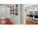 Open-concept living room with built-in bookshelves, hardwood floors, and dining area, perfect for gatherings at 410 N Hyde Park Ave, Durham, NC 27703