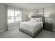 Cozy bedroom with large window, neutral decor, and comfortable furnishings at 425 Grand Silo Rd, Garner, NC 27603