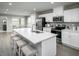 Modern kitchen with white cabinets, stainless steel appliances, and a large kitchen island at 425 Grand Silo Rd, Garner, NC 27603