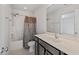 The bathroom has a bathtub and shower with a curtain and a vanity with a large mirror at 433 Mockingbird Ln, Mebane, NC 27302