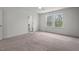 Bright bedroom with neutral carpet and two windows that look out into a wooded area at 433 Mockingbird Ln, Mebane, NC 27302