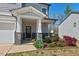 Inviting front porch with stone accents and a beautifully landscaped garden bed at 433 Mockingbird Ln, Mebane, NC 27302
