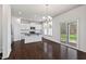 Well-lit kitchen and dining area with white cabinets, stainless steel appliances, and access to backyard at 433 Mockingbird Ln, Mebane, NC 27302