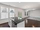 Kitchen island with hardwood floors, modern appliances, and an open view of the adjacent living space at 433 Mockingbird Ln, Mebane, NC 27302