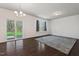 Bright living room with hardwood floors, large windows, and a sliding door to the outside at 433 Mockingbird Ln, Mebane, NC 27302
