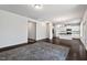 Spacious living area with hardwood floors, white walls, and an open layout leading to the kitchen at 433 Mockingbird Ln, Mebane, NC 27302