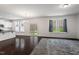 Open-concept living room with hardwood floors, abundant natural light, and access to the backyard at 433 Mockingbird Ln, Mebane, NC 27302