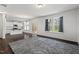 Bright living room with an open floor plan, hardwood floors, and a view of the kitchen and backyard at 433 Mockingbird Ln, Mebane, NC 27302