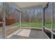 Enclosed screened porch with views of the fenced yard and wooded area, perfect for outdoor living at 433 Mockingbird Ln, Mebane, NC 27302