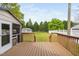 Wooden back deck overlooking the fenced backyard and surrounding mature trees at 440 S Church St, Coats, NC 27521