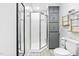 Well-lit bathroom with a glass shower, storage cabinets, and tiled floors at 440 S Church St, Coats, NC 27521