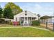 Charming home featuring a cozy, screened front porch and well-maintained landscaping at 440 S Church St, Coats, NC 27521