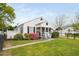 Exterior view of a charming home showcasing a screened porch and landscaped yard at 440 S Church St, Coats, NC 27521