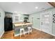 Bright kitchen boasts an island with seating, butcher block countertops, and stainless steel appliances at 440 S Church St, Coats, NC 27521