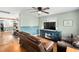 Cozy living room featuring a ceiling fan and view into the kitchen area at 440 S Church St, Coats, NC 27521