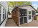 Side view of the wooden back deck and enclosed, screened-in porch at 440 S Church St, Coats, NC 27521