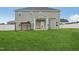 Grassy backyard with white fence, featuring a covered patio and a pergola with seating at 45 Pond Mountain Dr, Clayton, NC 27520