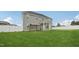 Spacious backyard featuring a well-maintained lawn, fenced perimeter, and covered patio seating area at 45 Pond Mountain Dr, Clayton, NC 27520
