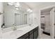 Modern bathroom featuring double sinks, white countertop, dark cabinets, and a view into the shower area at 45 Pond Mountain Dr, Clayton, NC 27520