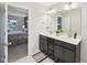 Bathroom showcasing a double vanity, framed mirror, and open access to the main bedroom at 45 Pond Mountain Dr, Clayton, NC 27520