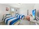 Bright bedroom with two twin beds, blue striped bedding, and a window view at 45 Pond Mountain Dr, Clayton, NC 27520