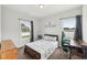 Cozy bedroom with two windows and a decorative accent wall and carpet flooring at 45 Pond Mountain Dr, Clayton, NC 27520