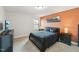 Cozy bedroom with cityscape art, a queen-sized bed, and natural light from a window at 45 Pond Mountain Dr, Clayton, NC 27520