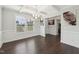 Formal dining room featuring coffered ceilings, wainscoting, hardwood floors and chandelier at 45 Pond Mountain Dr, Clayton, NC 27520