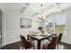 Formal dining room with coffered ceilings, wainscoting, chandelier and large window at 45 Pond Mountain Dr, Clayton, NC 27520