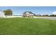Expansive front yard view of a two-story home with white vinyl fencing at 45 Pond Mountain Dr, Clayton, NC 27520